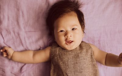 A baby smiling into the camera