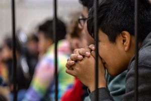 Students listen to a presentation by police during a school assembly