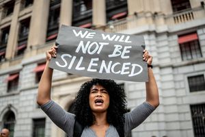 Woman holding signs during on a demonstration outdoors