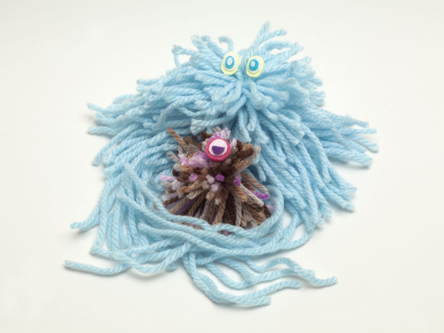 Wool doll natural killer cell engulging a wool cancer cell