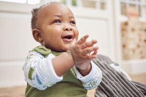 baby smiling and clapping