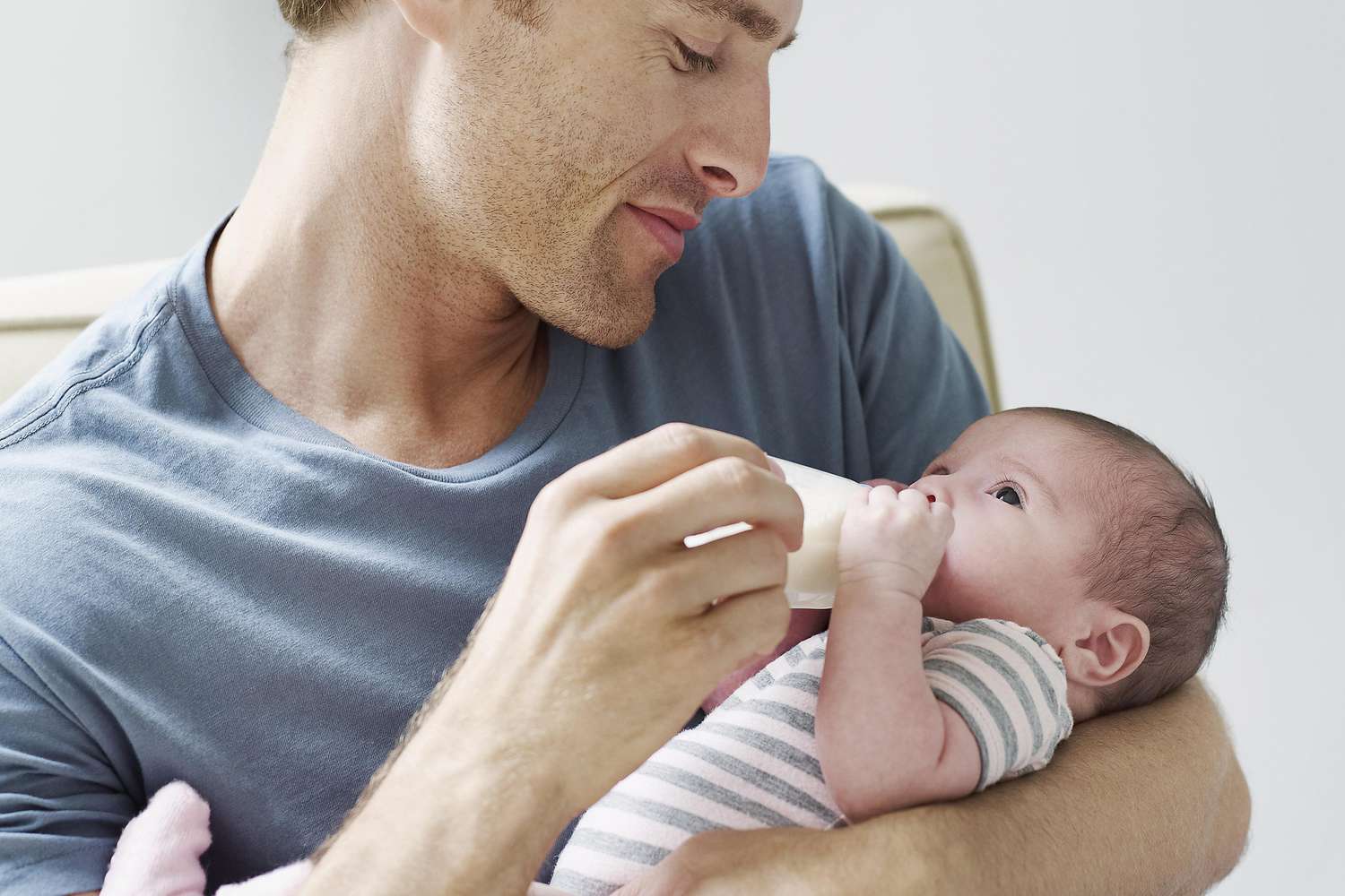 Father feeding an infant a bottle