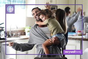 Justin Baldoni holding his child in the kitchen