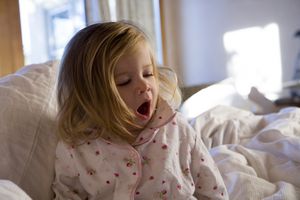 Toddler girl yawning