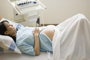 Pregnant woman lying on hospital bed, elevated view