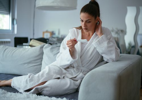 Worried girl after looking a pregnancy test