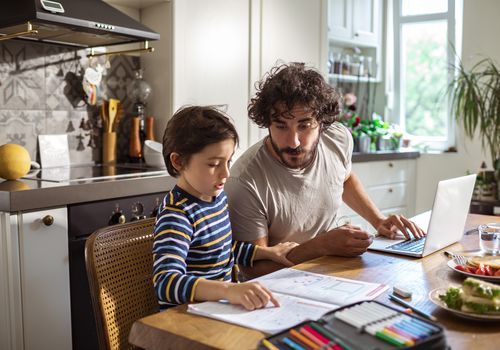 Father helping his son with schoolwork