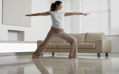 Pregnant Woman in Yoga Position in Room