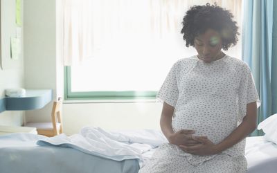 pregnant black woman in hospital gown