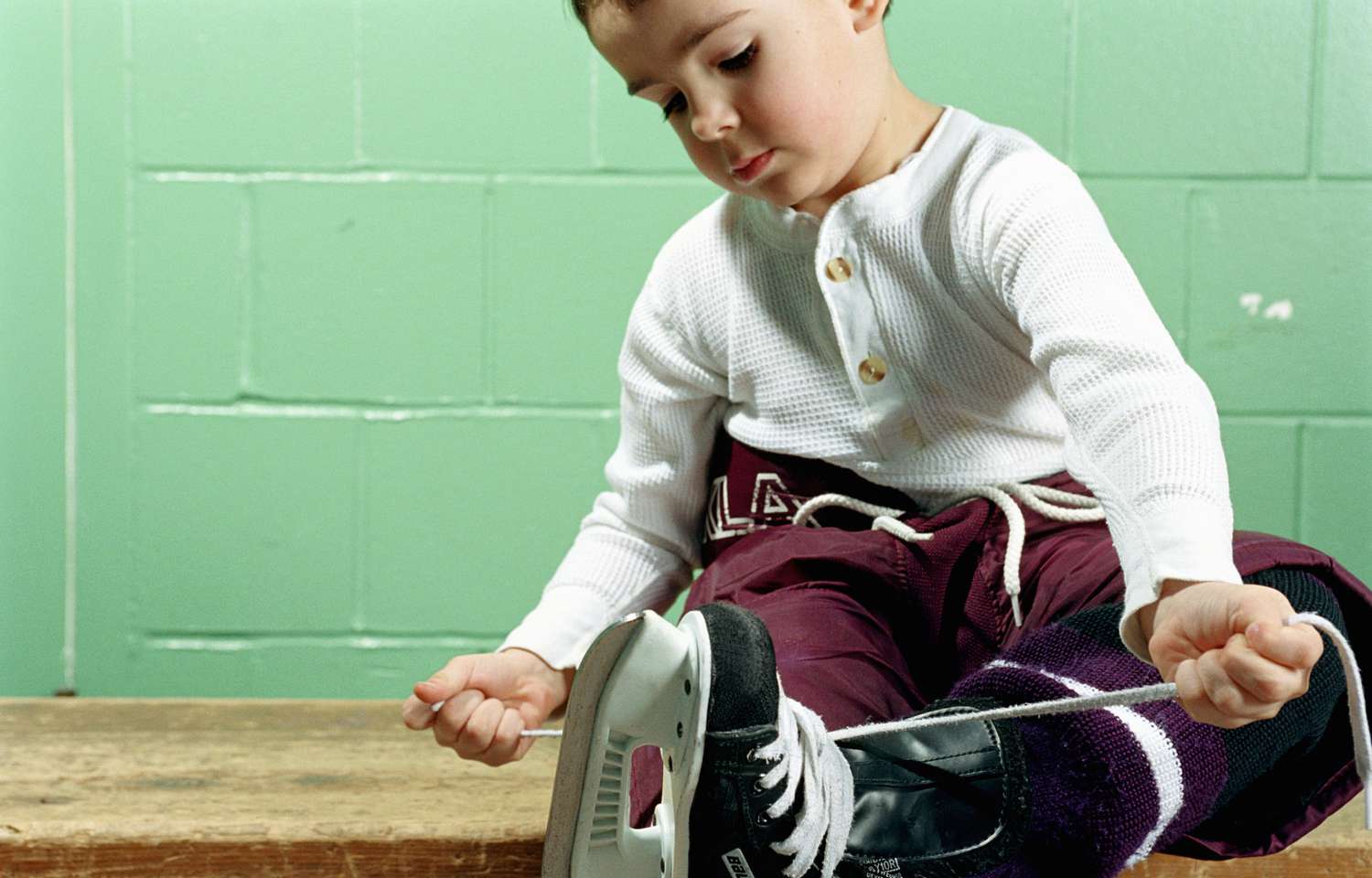 boy tying hockey skates