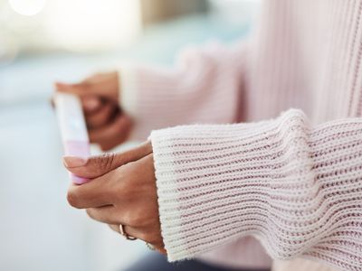Woman checking pregnancy test after taking Clomid