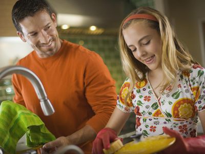 Teen girl helping to wash the dishes