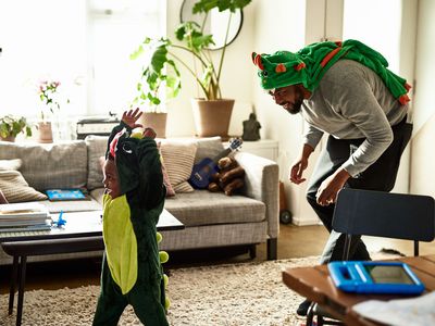 BIPOC man playing with his kid.