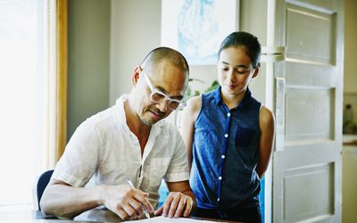 Father helping daughter with time management