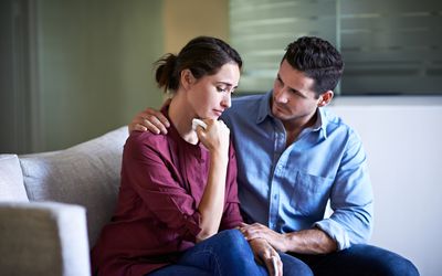 Man comforting sad woman