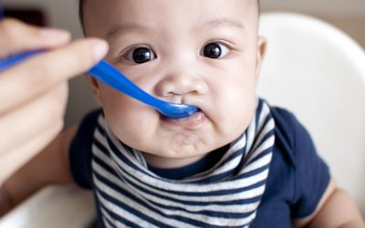 Feeding a baby for the first time with solid food