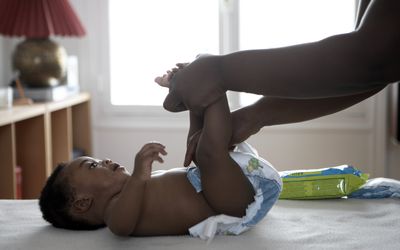 mother changing her baby's diaper