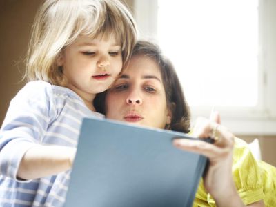 Mother reading to daughter.