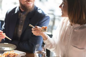 Couple eating sushi and smiling
