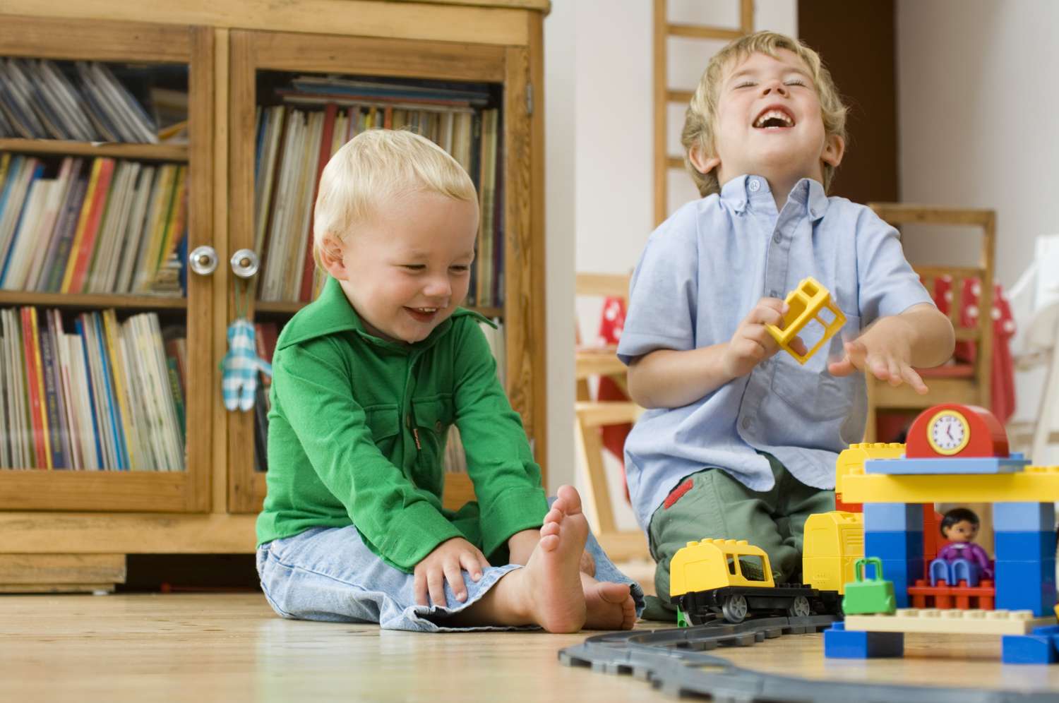 toddler boys playing with trains
