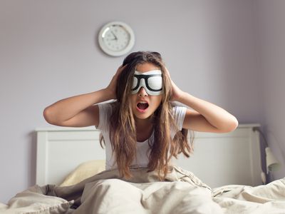 Young woman trying to get out of bed