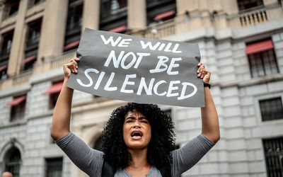 Woman holding signs during on a demonstration outdoors