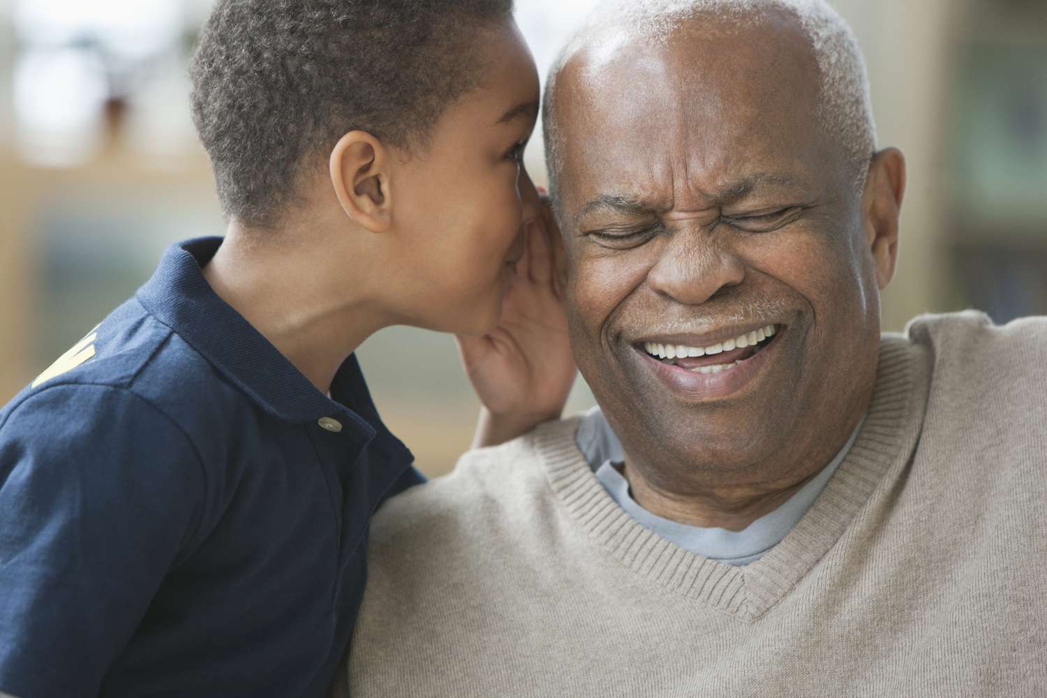 Boy telling grandfather a joke