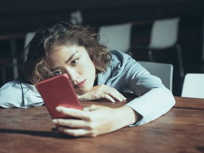 Sad young woman on smartphone