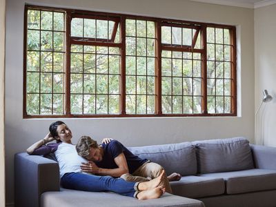 man and pregnant woman on couch