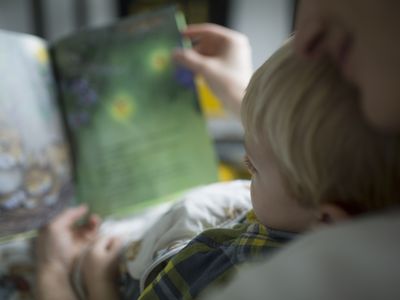 Child looking at picture book with mom